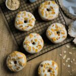 Tasty almond glazed donuts on a cooling rack perfect for food lovers.