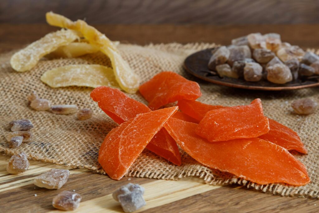 Vibrant dried fruits on burlap, showcasing natural textures and colors.